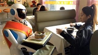 In Beijing Robot Waitresses Are Happy to Serve [upl. by Enymsaj]