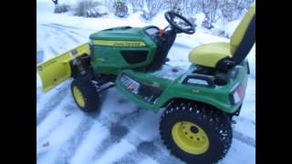 Plowing snow with a John Deere X738  Wow [upl. by Akyeluz]